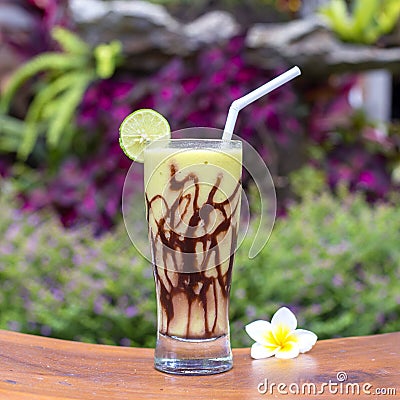 Fresh organic green smoothies from avocado, banana, cocoa and honey in glass on wooden table. Close up Stock Photo
