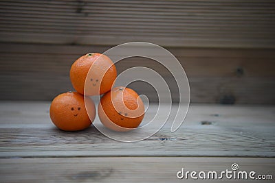 Healthy food photography image of fresh organic oranges with happy drawn on smile on rustic wood background with copy space Stock Photo