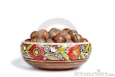 Fresh organic peeled macadamia nuts in ceramic bowl isolated on white Stock Photo