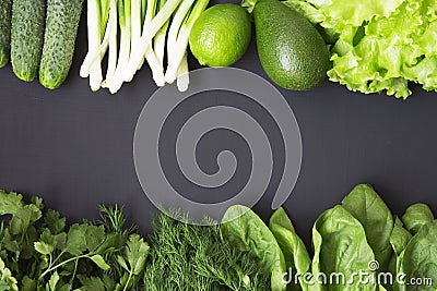 Fresh organic raw produce. Green toned vegetables and fruits on dark background. Stock Photo