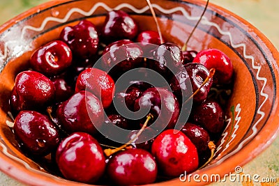 Fresh organic sweet cherries on ceramic bowl Healthy food concept. Summer fruits. Red fresh cherry Stock Photo