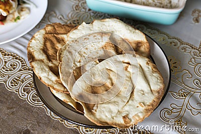 Fresh oven baked naan on wooden table Stock Photo