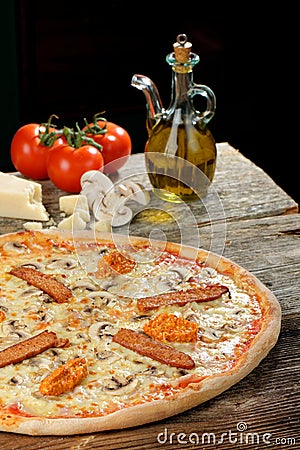 Fresh Oven Baked Pizza with ham, Sausage, All Cheese Stock Photo