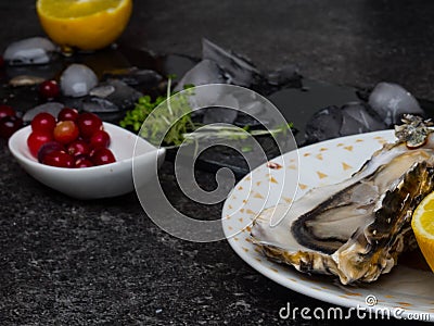 Fresh Oysters in plate, lemon, shells on marble. Delicacy super food, rich in antioxidants, vitamin, zinc Stock Photo