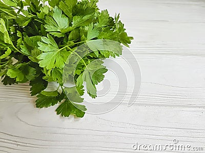 fresh parsley bunches seasoning organic on a white wooden background Stock Photo