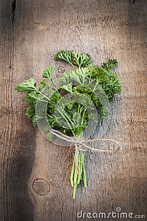 Fresh parsley on vintage wooden board Stock Photo