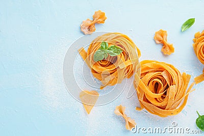 Fresh pasta background with flour and basil on blue background Stock Photo