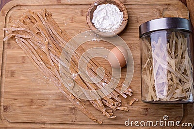 Fresh pasta with components to do it : wholemeal flour and egg o Stock Photo