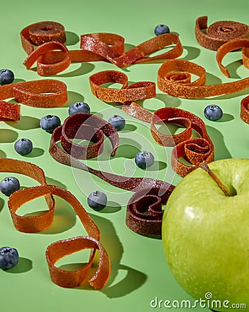 Fresh pastille from apples and blueberries in green studio Stock Photo