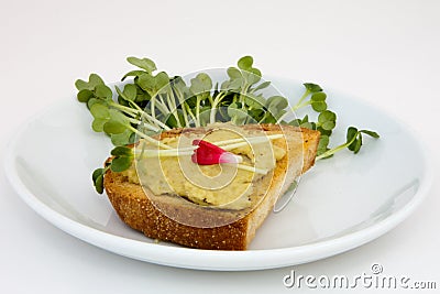 Fresh Pea Hummus Crostini with Pea Tendril Garnish Stock Photo