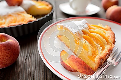 Fresh peach pie sprinkled with sugar on wooden background Stock Photo