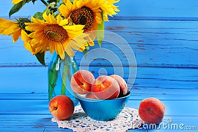 Fresh peaches and sunflowers Stock Photo