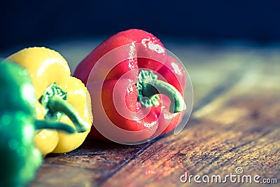 Fresh peppers red, green, yellow on wooden board Stock Photo