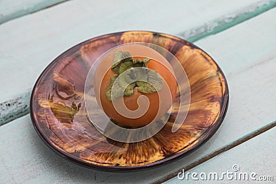 Fresh persimmon on a plate of frui Stock Photo