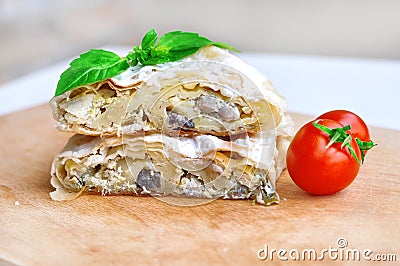 Fresh piece of savory strudel stuffed with chicken meat and mushrooms s Stock Photo