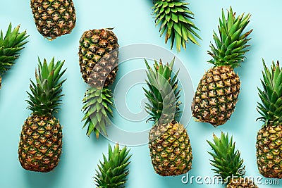 Fresh pineapples on blue background. Top View. Pop art design, creative concept. Copy Space. Bright pineapple pattern Stock Photo