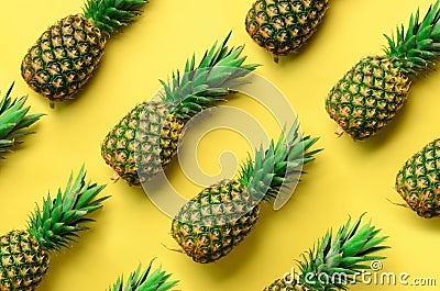 Fresh pineapples on yellow background. Top View. Pop art design, creative concept. Copy Space. Bright pineapple pattern Stock Photo