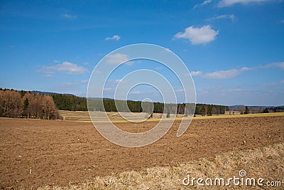 Fresh plowed farmland in march under a blue sky Stock Photo