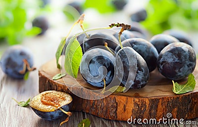 Fresh plums with leaves Stock Photo