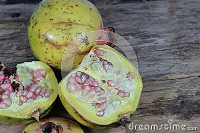 Open section of a pomegranate fruit exposing the ripe red seeds within. Healthful natural fruits for cancer patient Stock Photo