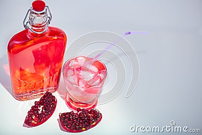 Freshly made Pomegranate Juice with full bottle and glass with straw. Stock Photo