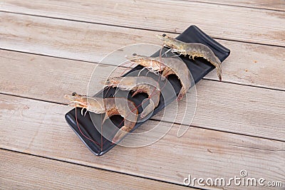 Fresh prawn ingredients are placed on a long plate on the table Stock Photo