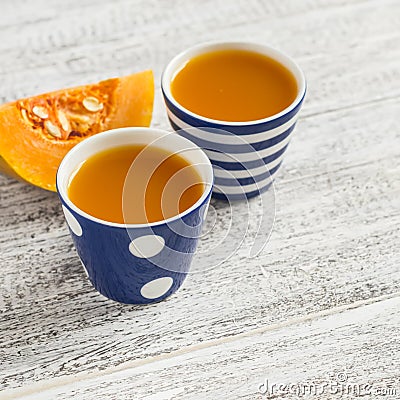 Fresh pumpkin juice in vintage ceramic cups Stock Photo