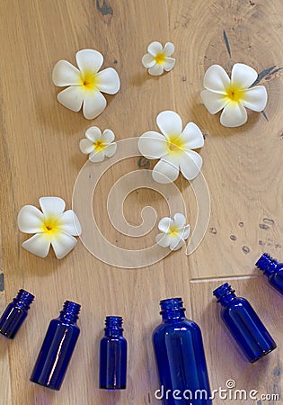 fresh pure flower essential oils exploding from protecting aromatherapy bottles Stock Photo