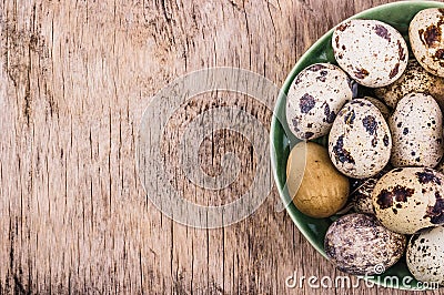 Fresh quail eggs on a wooden board. Vegetarian diet. Copy space. Stock Photo