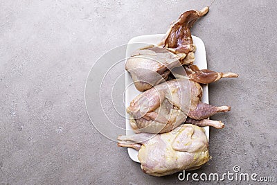 some plucked quails ready for cooking on a white background Stock Photo