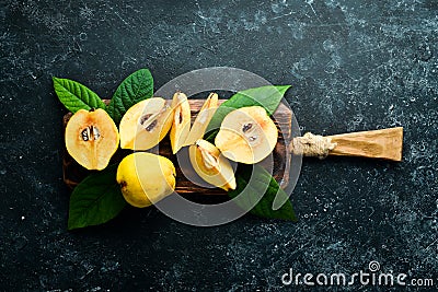 Fresh quince fruits on a wooden board. Stock Photo