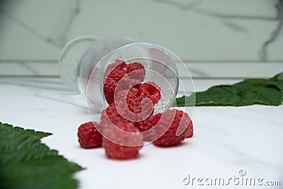 Fresh raspberries in a glass on the table. Healthy and vitamine food Stock Photo