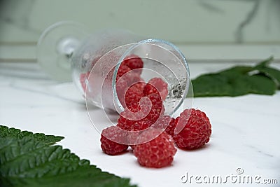 Fresh raspberries in a glass on the table. Healthy and vitamine food Stock Photo