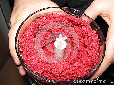 Fresh raspberry chopped in a blender in the hands Stock Photo