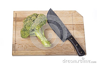 Fresh raw broccoli, cutting board made of wood on a white background. a large knife for cutting in the kitchen Stock Photo