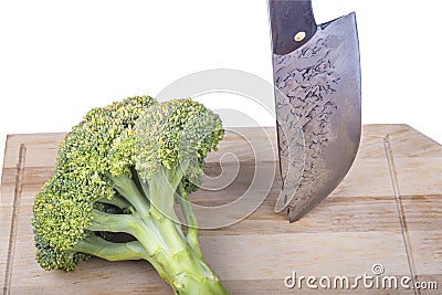 Fresh raw broccoli, cutting board made of wood on a white background. a large knife for cutting in the kitchen Stock Photo