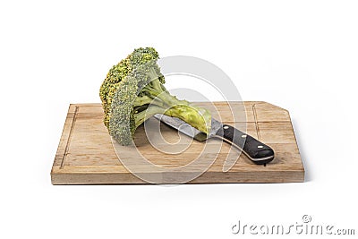 Fresh raw broccoli, cutting board made of wood on a white background. a large knife for cutting in the kitchen Stock Photo