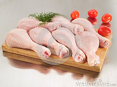 Fresh raw chicken legs on cutting board Stock Photo