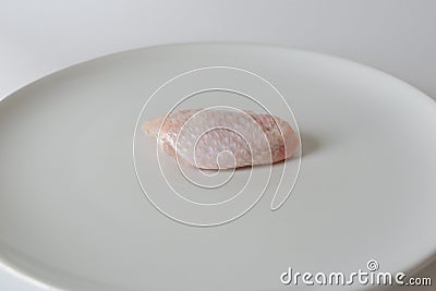 Fresh raw chicken wings on white dish with white background Stock Photo