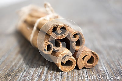 Fresh raw cinnamon sticks on wooden table tied with jute natural twine Stock Photo