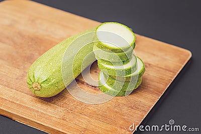 Fresh raw green courgette or zucchini whole and sliced Stock Photo