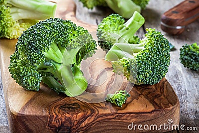 Fresh raw organic broccoli cutting board closeup Stock Photo