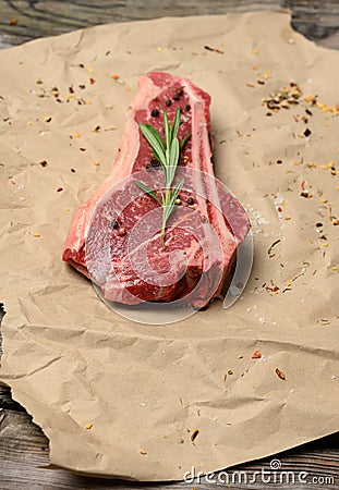 Fresh raw piece of beef meat, striploin steak on a paper background, top view. Marbled piece of meat Stock Photo