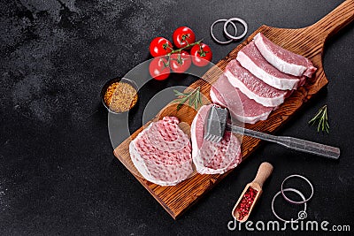 A fresh raw piece of pork escalop cut into several parts Stock Photo