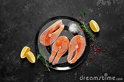 Fresh raw salmon fish steaks with cooking ingredients on kitchen table, healthy food, source of omega-3 Stock Photo