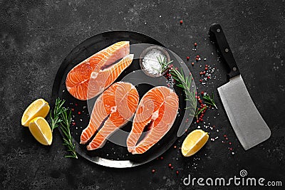 Fresh raw salmon fish steaks with cooking ingredients on kitchen table, healthy food, source of omega-3 Stock Photo