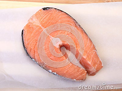 Fresh raw salmon with spices on wooden cutting board. ready for cookin Stock Photo