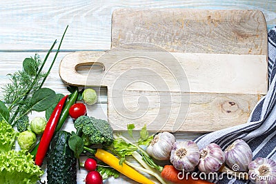 Fresh raw vegetables and empty cutting board food diet background concept Stock Photo