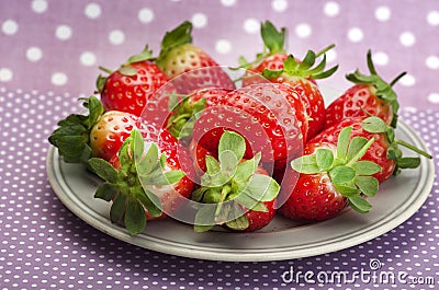 Fresh red ripe strawberries on dotty background Stock Photo