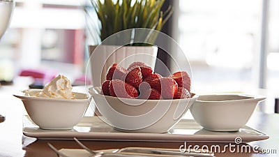 Fresh red strawberries with cream om white wood table. Easy diet Stock Photo